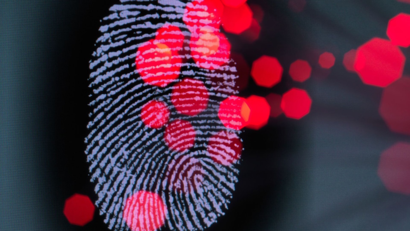 Close-up of a fingerprint with red glowing nodes, symbolizing cybersecurity and data tracking