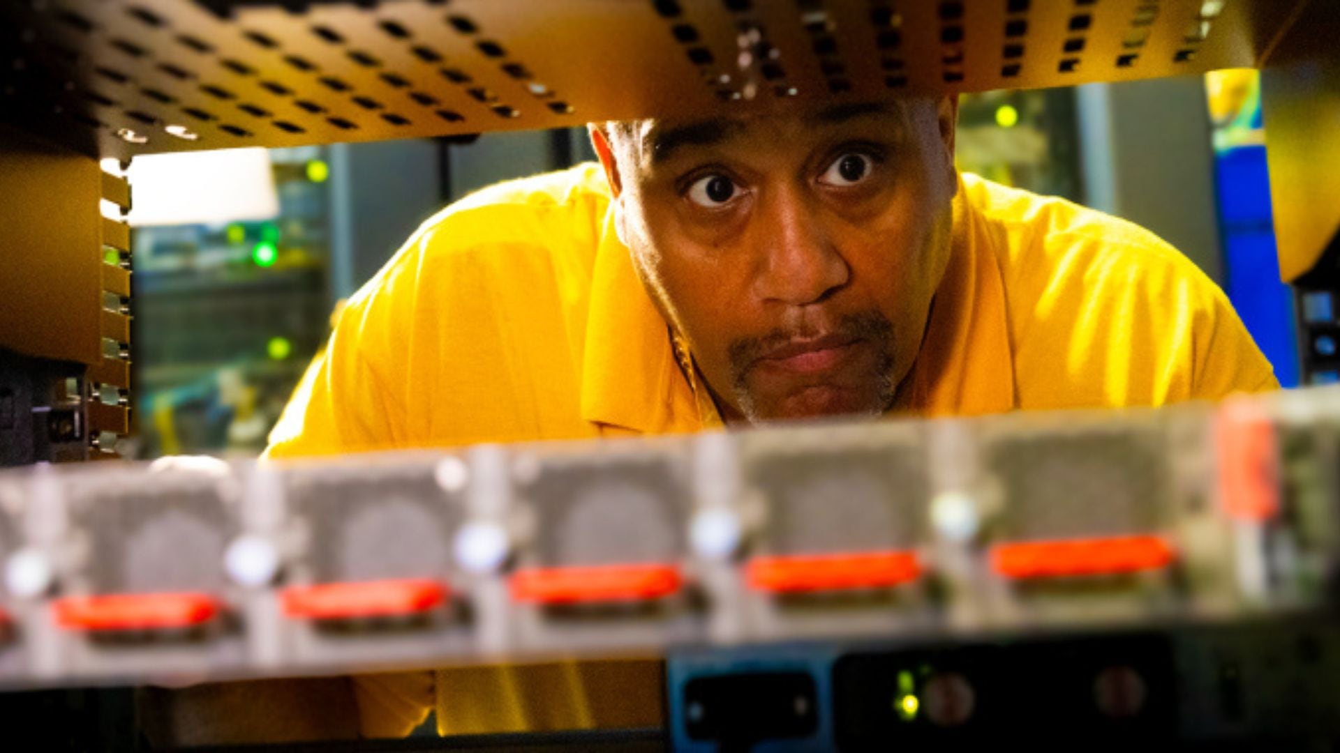An engineer looking at a data rack