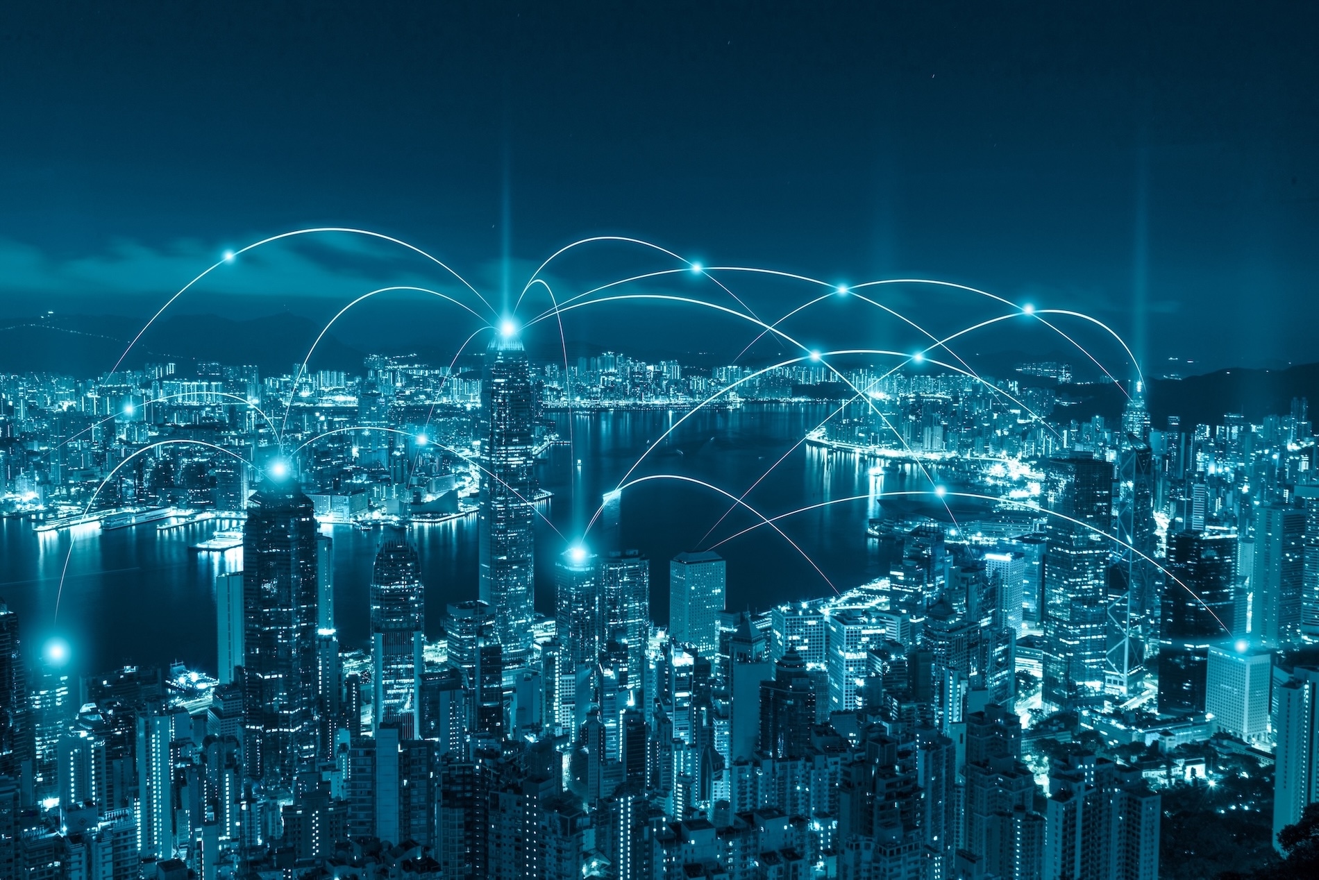 Night city skyline with glowing network connections linking buildings across an urban waterfront.