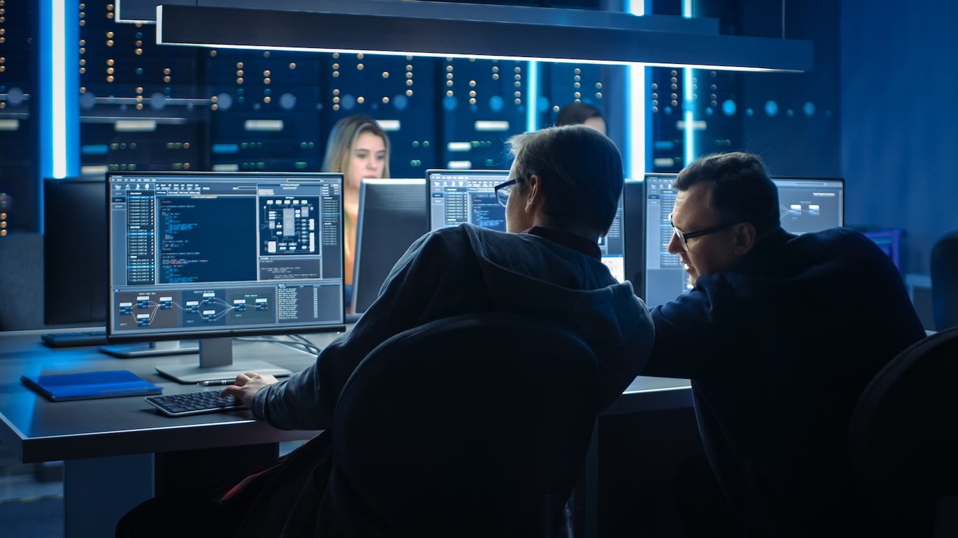 People in control room looking at monitors