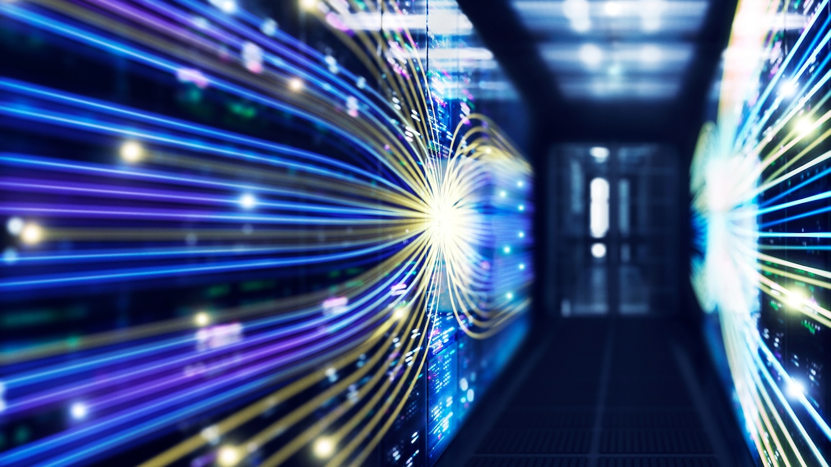Fiber optic cables glowing in a dark data center corridor with high-speed light trails.