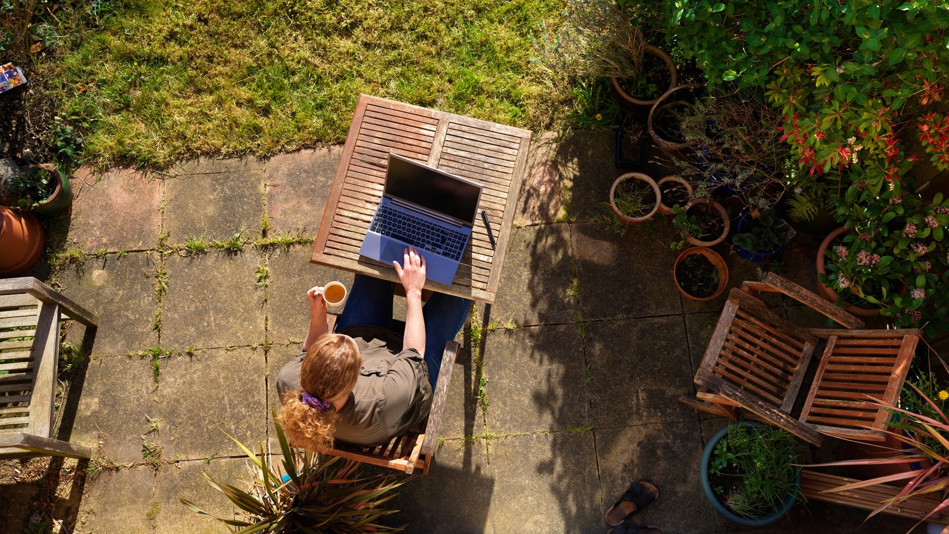women sitting garden with laptop