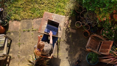 women sitting garden with laptop