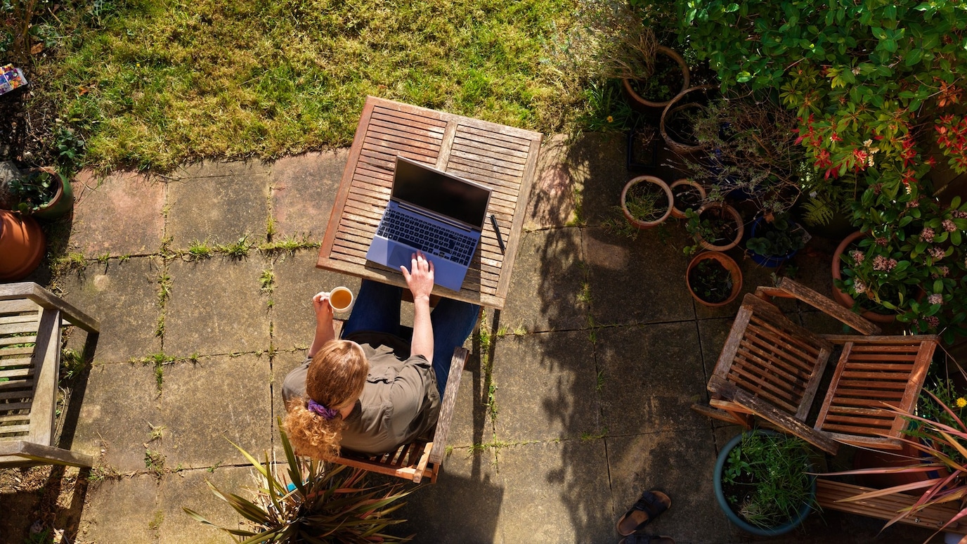 women sitting garden with laptop