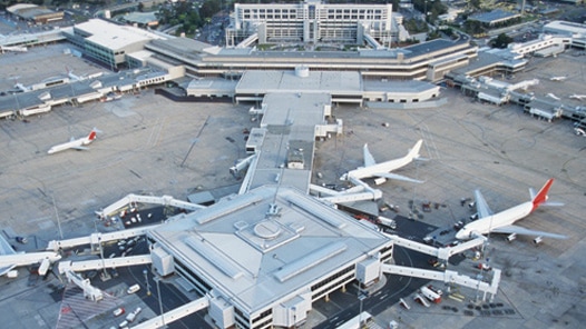 Planes gathered around a gate at an airport