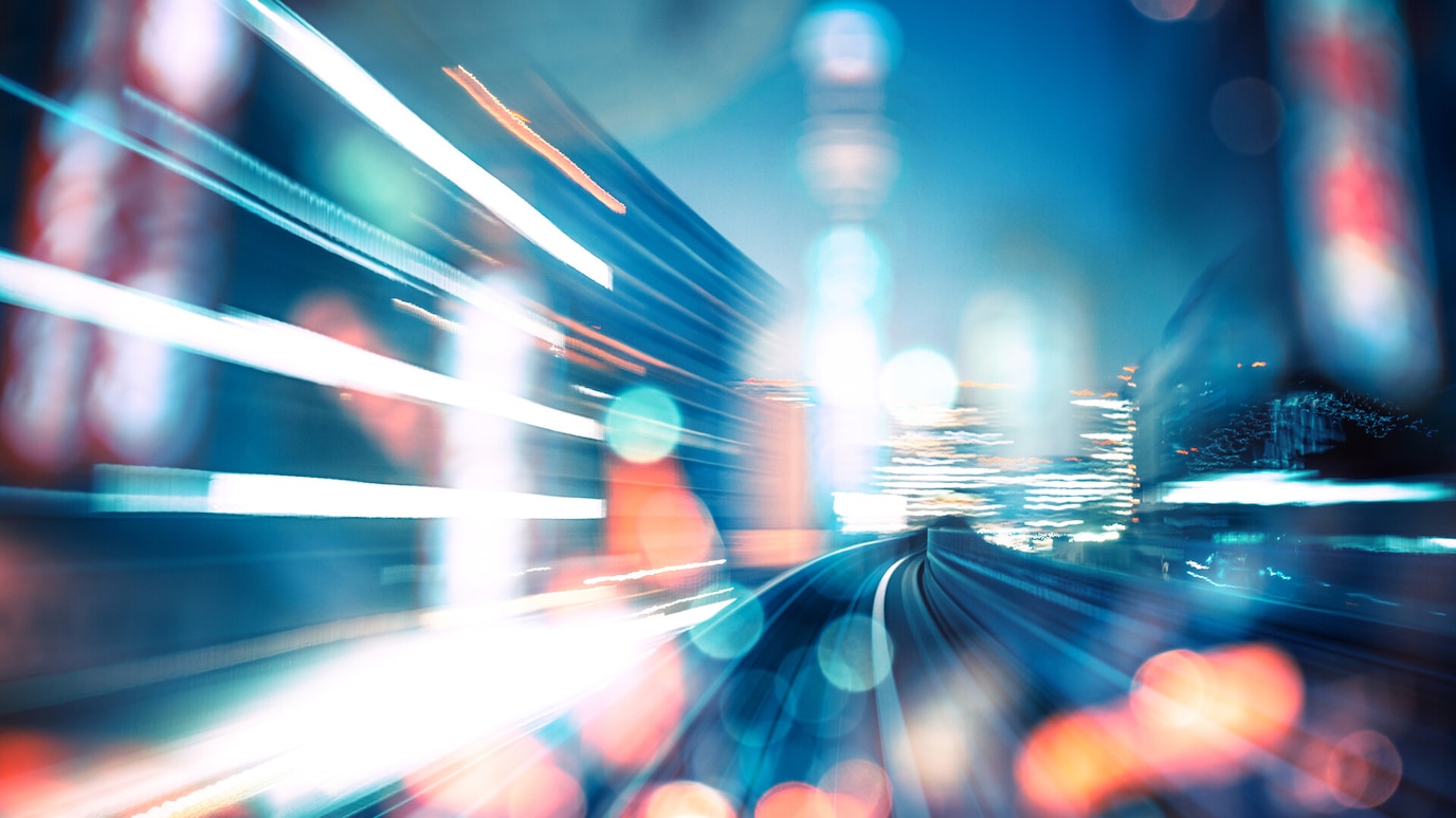 Blurred view along railtracks through rain-spotted lens