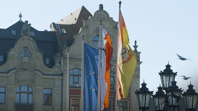 Flags flying in front of buildings in in Wrocław