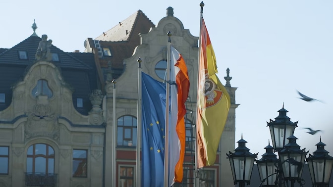 Flags flying in front of buildings in in Wrocław