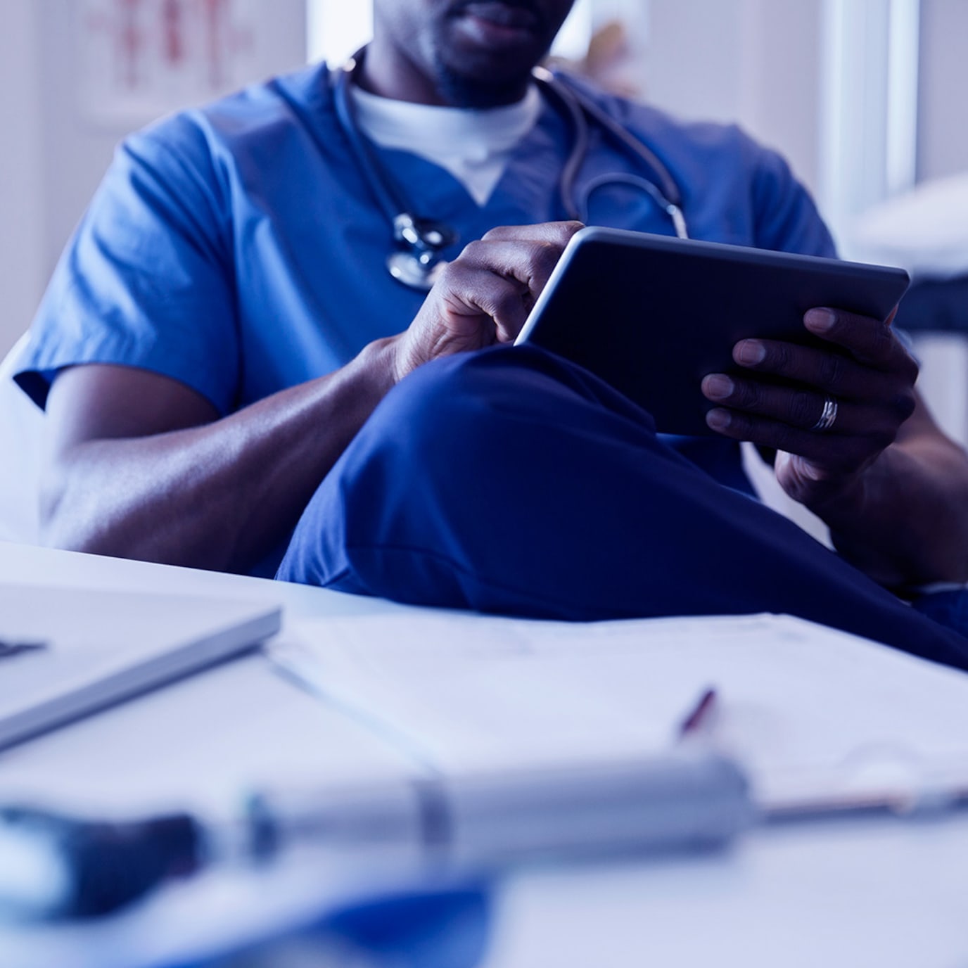 Medical professional looking at tablet device