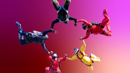 Skydivers linking hands
