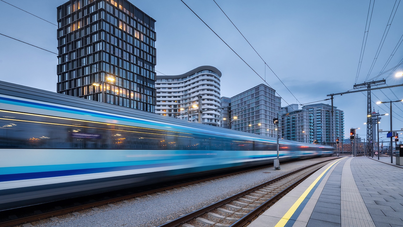 Blurred train passing at speed through train station