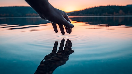 hand touching water surface