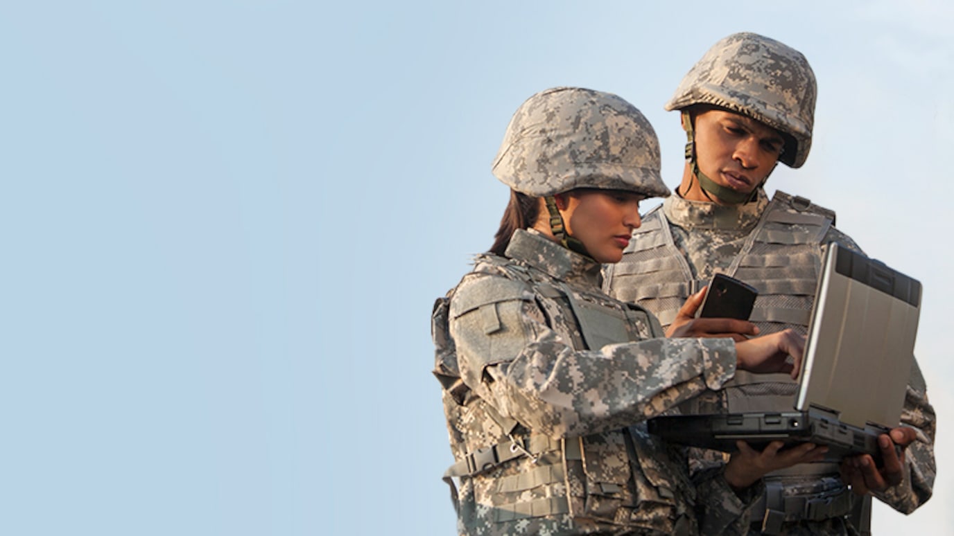 Two soldiers looking at a tablet device