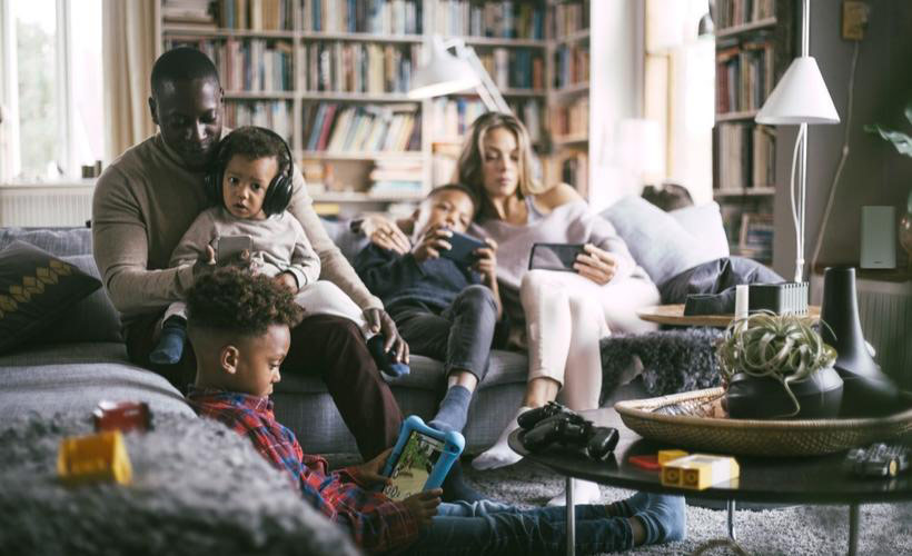 Family using wireless devices in living room