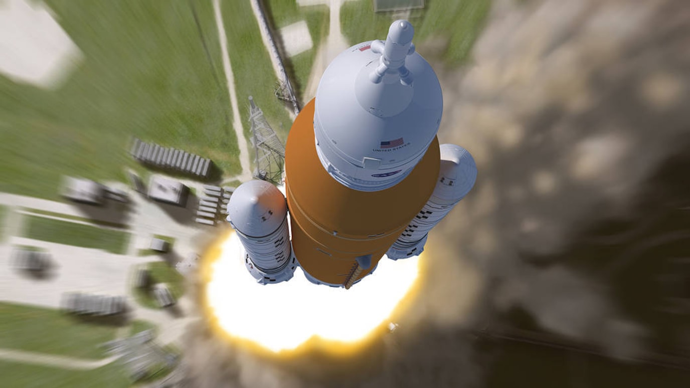 Aerial view looking down at NASA's Artemis I rocket during liftoff.