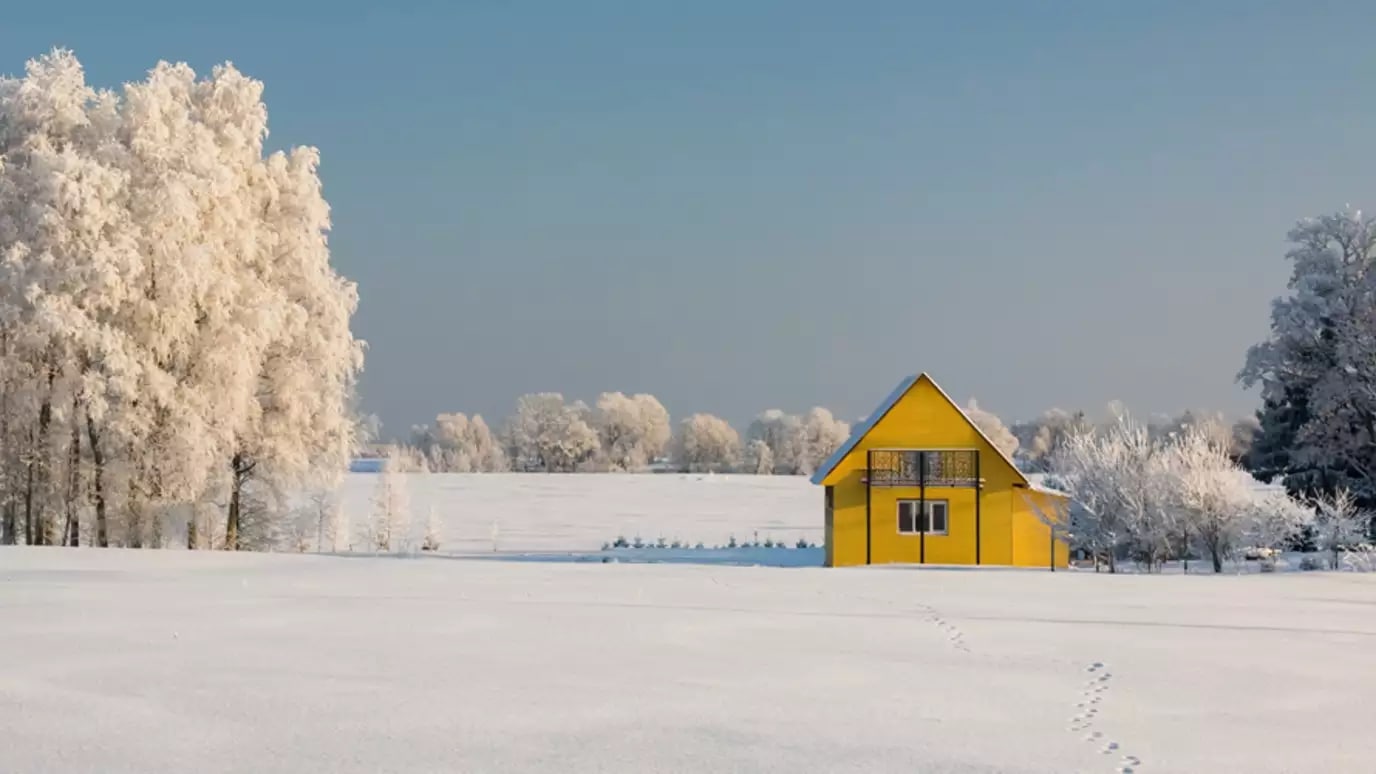 yellow house in winter landscape