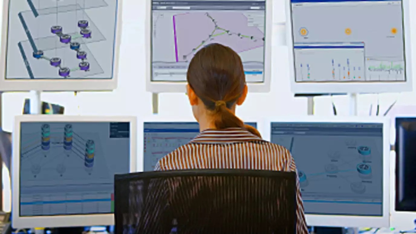 Photo of a woman monitoring screens