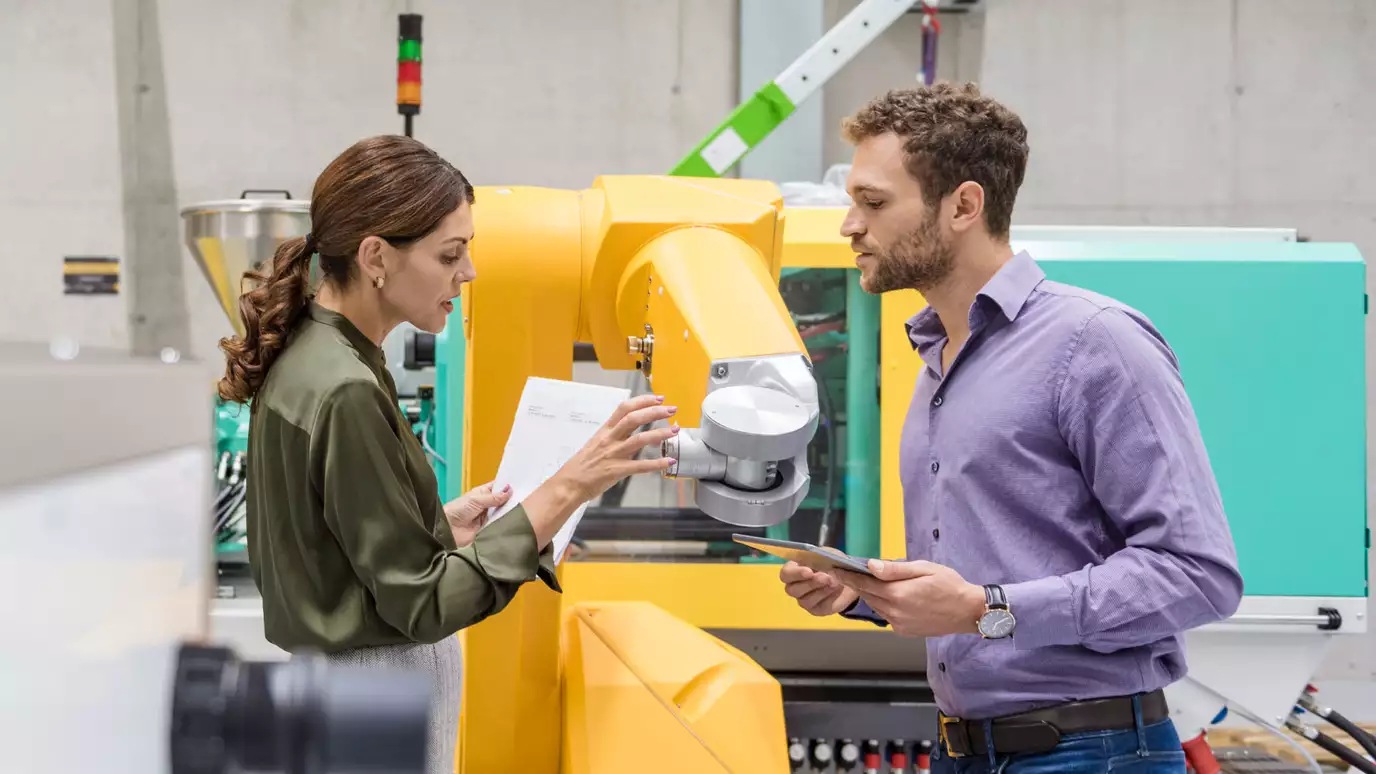 man and woman by a machine