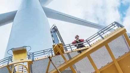 Engineer looking down from gantry on a wind turbine