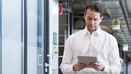 A person working on tablet in a data center