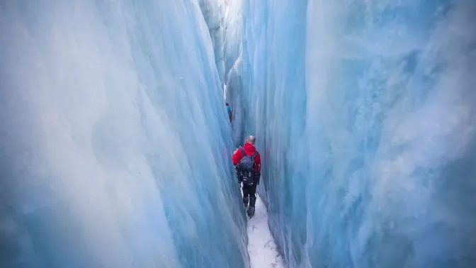 Man hiking in a glacier crevasse