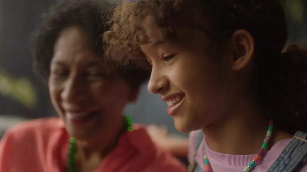 a girl and adult smiling