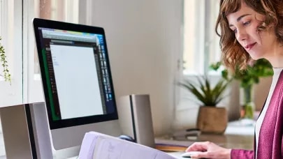 An image of a person working in a bright home office setting.