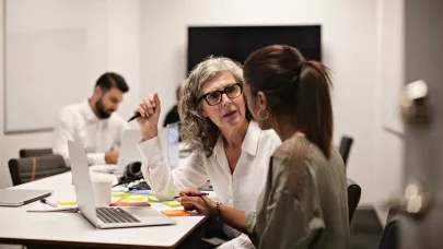 Two women working in front of a laptop