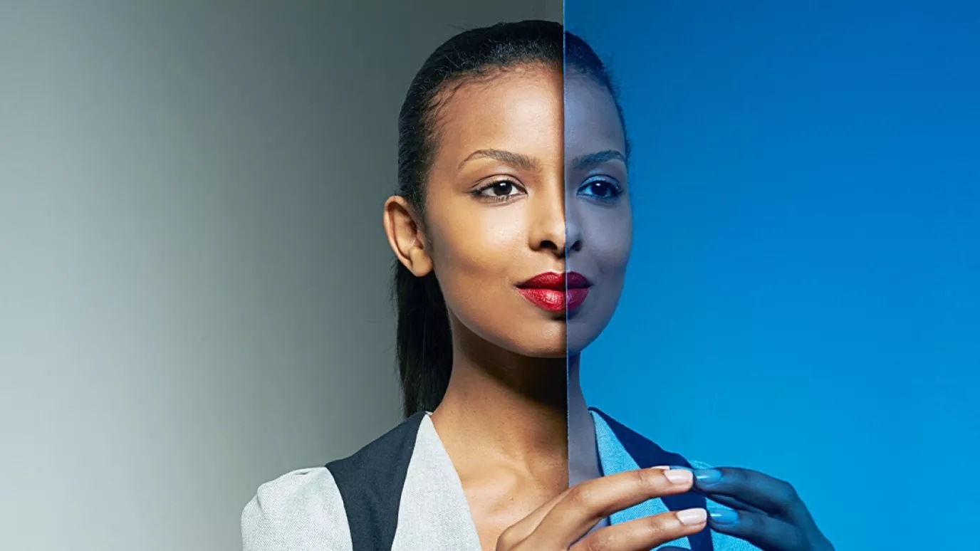 A woman and her image in the mirror.