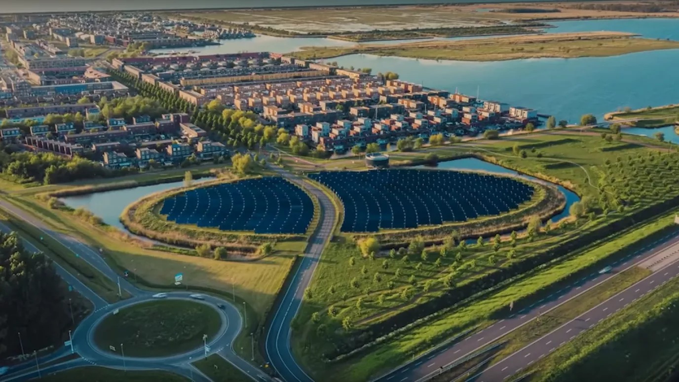 An image that shows urban infrastructure, greenery and bodies of water.