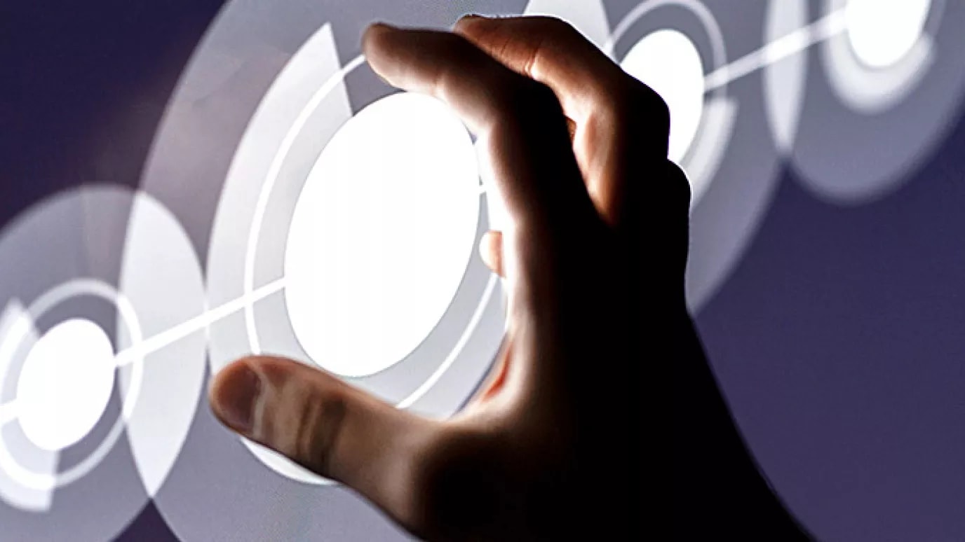 A hand reaching out to touch a digital circle.
