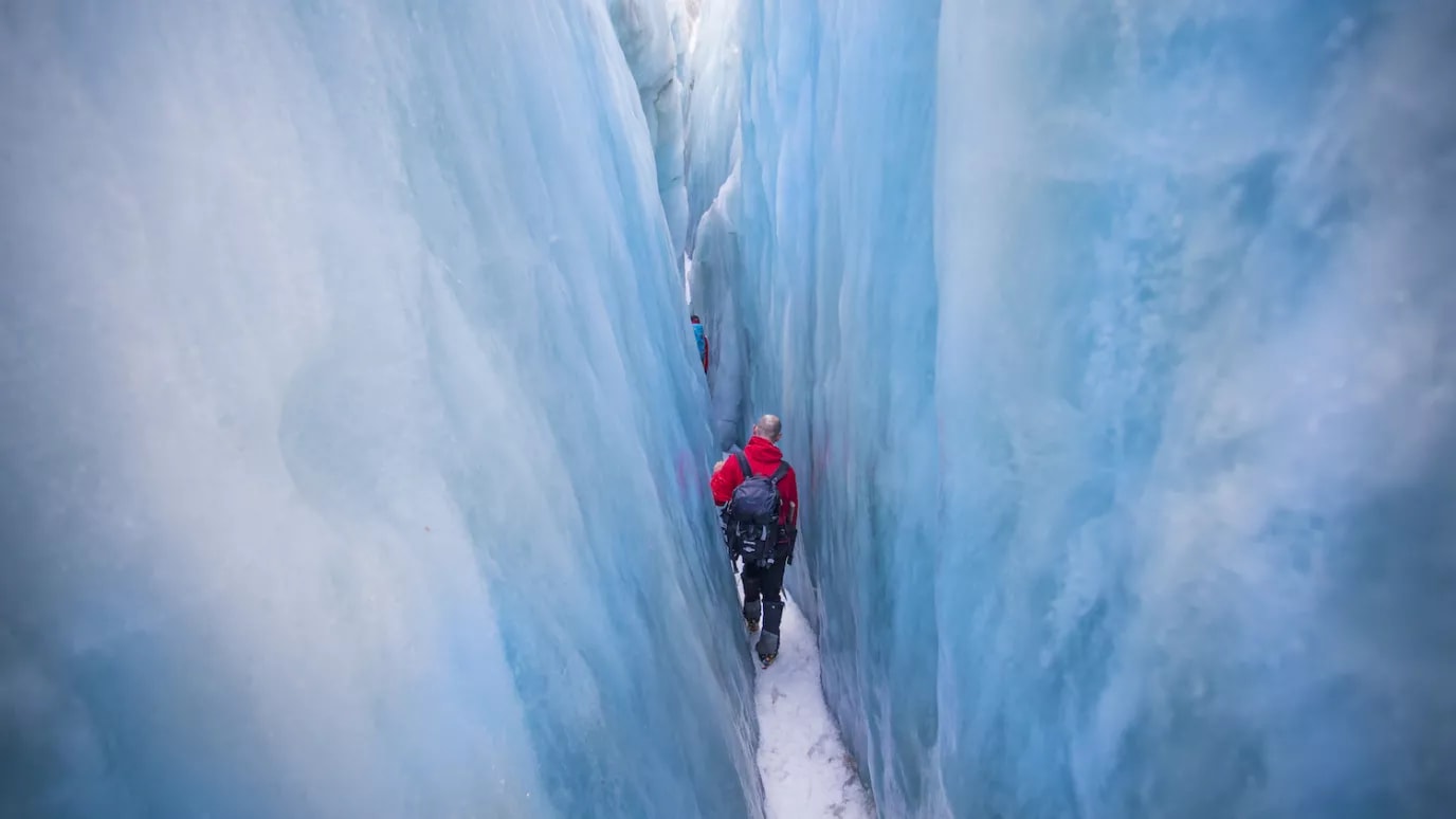Man hiking in a glacier crevasse