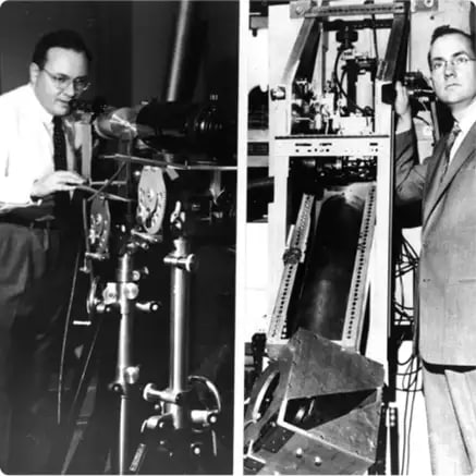 Two scientists in laboratory working on laser equipment