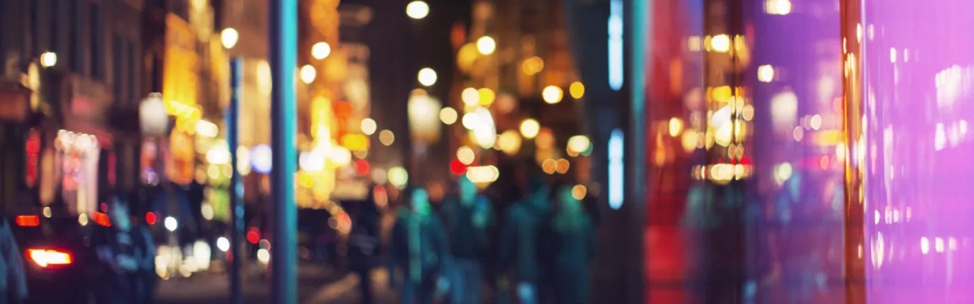 A blurry picture of colourful nighttime city lights.