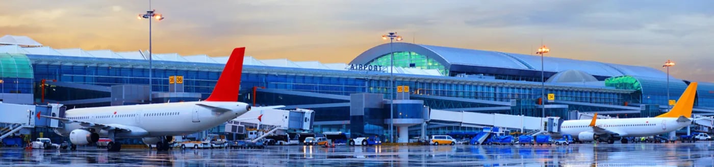 Parked planes on runway by gates