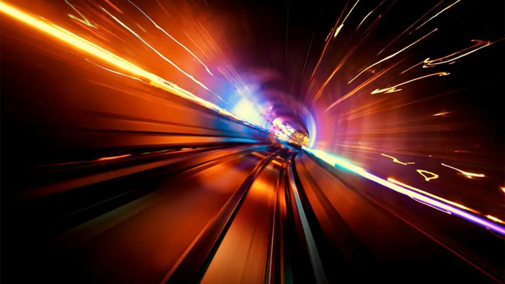 A fast-moving vehicle traveling through a tunnel. The lights and the motion blur create a sense of speed and energy.