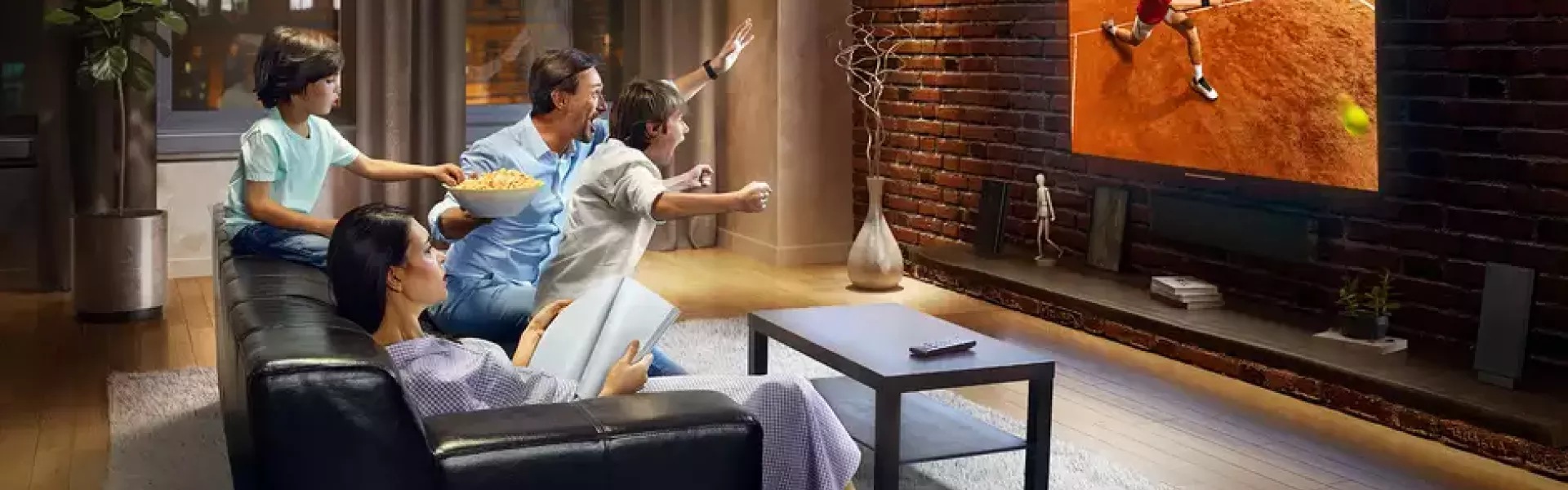 A family watching a tennis match on tv.