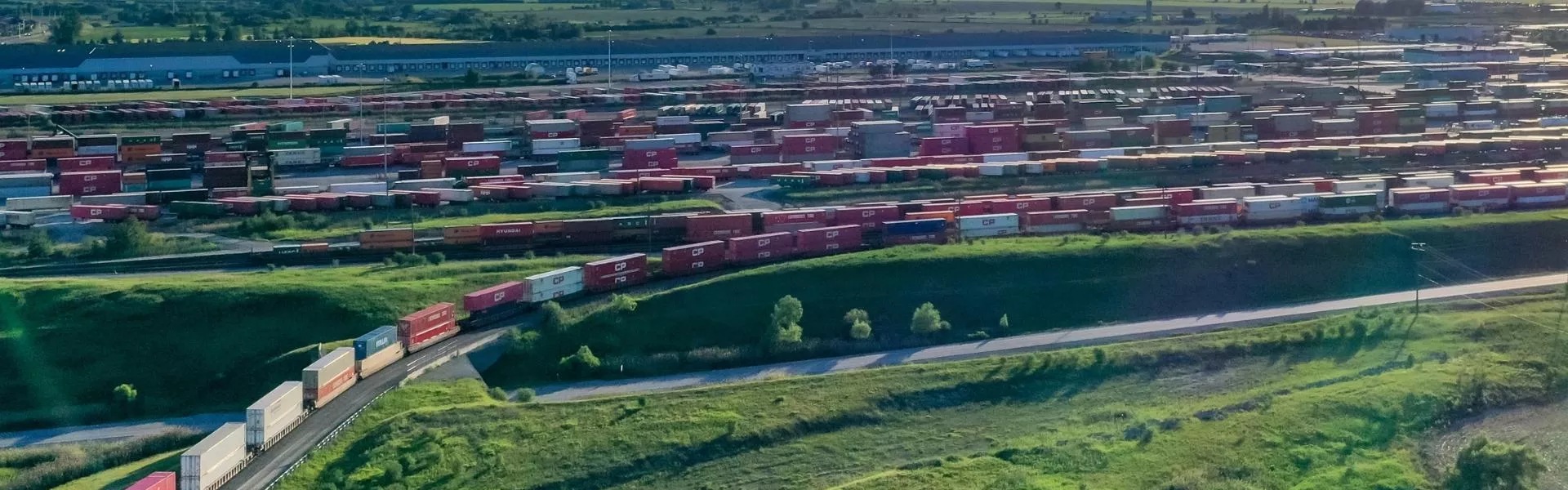An image showing a railway yard filled with trains.