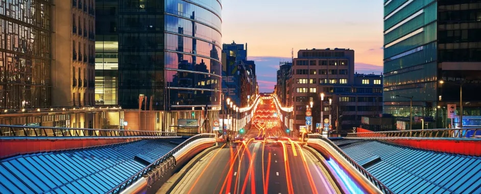 Road with long exposure city lights at night