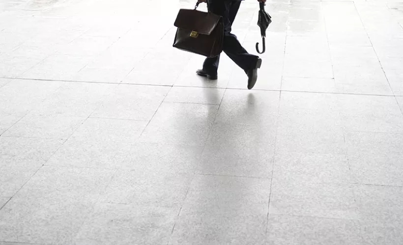 Man carrying briefcase and umbrella