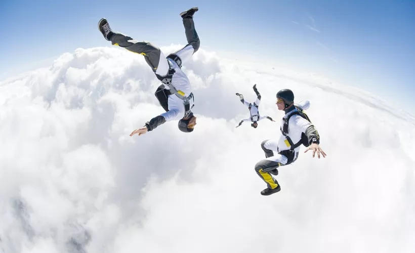 Photo of skydivers in the clouds