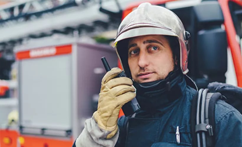 Firefighter talking on a radio phone