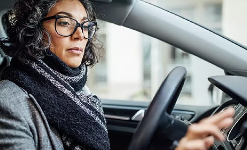 Automotive licensing woman using applience in car