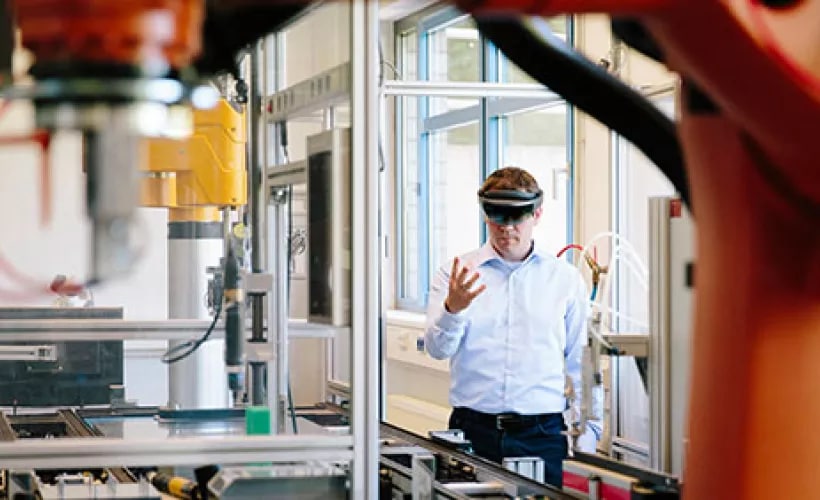 Man using smart glasses in factory