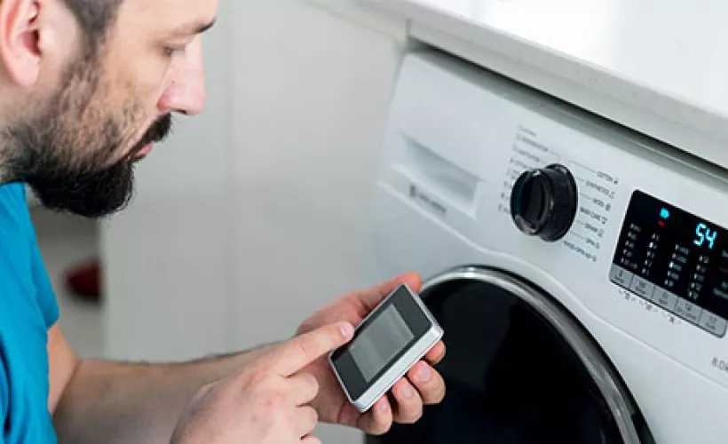Man operating a washing machine