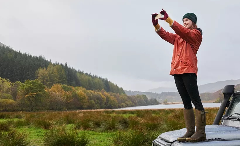 Woman capturing nature with mobile device