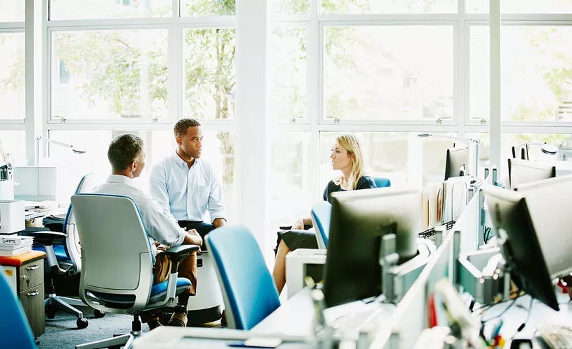 people chatting in office