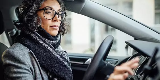 Automotive licensing woman using applience in car