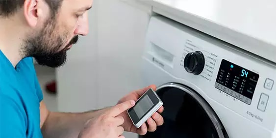 Man operating a washing machine