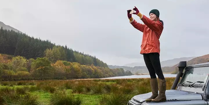 Woman capturing nature with mobile device